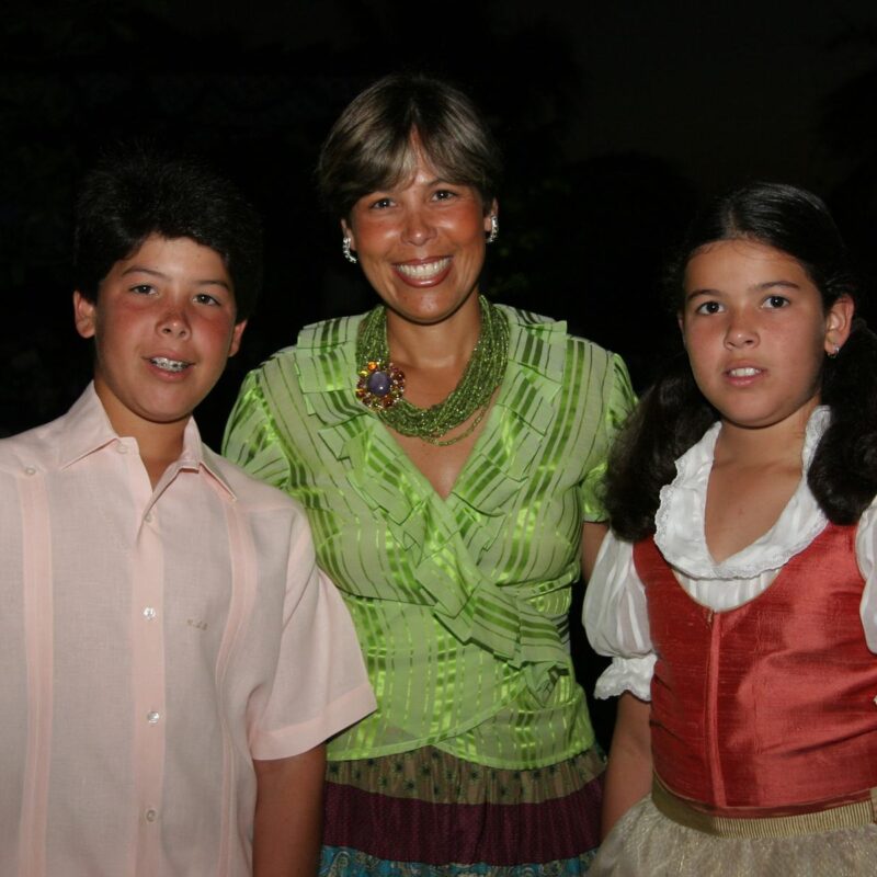 Dos jóvenes con trajes tradicionales junto a una invitada en la gala de 2006
