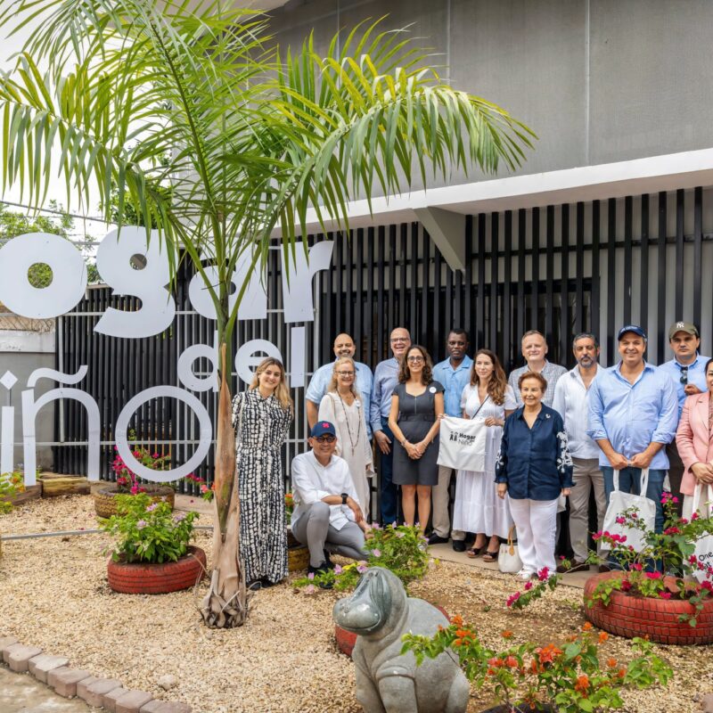Delegación de embajadores de la ONU frente al rótulo de la Escuela Hogar del Niño